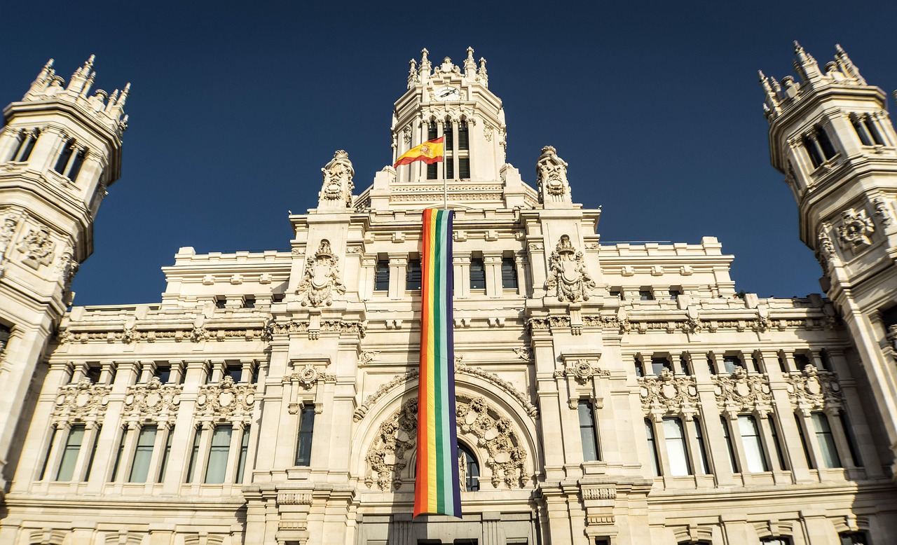 gay pride, gay flag, rainbow flag, monument, madrid, architecture, spain, building, palace, colossal, perspective, city, europe, urban landscape, cybele monument, facade